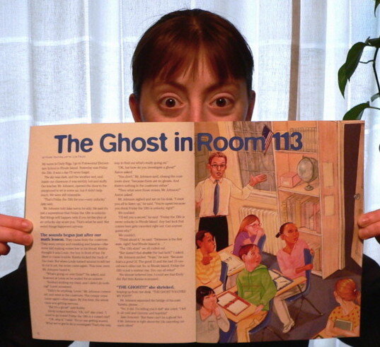 rowena zahnrei peeking over the top of an open magazine